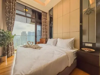 a bedroom with a large bed with a large window at TRX Pavilion Top Floor Suite, Kid-Friendly Slide, Dorsett Bukit Bintang KL, Kuala Lumpur Malaysia in Kuala Lumpur