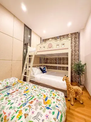 a bedroom with a bunk bed and a giraffe toy at TRX Pavilion Top Floor Suite, Kid-Friendly Slide, Dorsett Bukit Bintang KL, Kuala Lumpur Malaysia in Kuala Lumpur