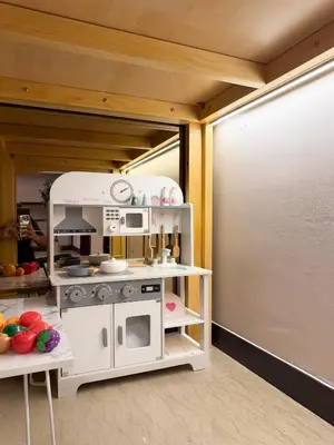 a toy kitchen with a pretend stove in a room at TRX Pavilion Top Floor Suite, Kid-Friendly Slide, Dorsett Bukit Bintang KL, Kuala Lumpur Malaysia in Kuala Lumpur