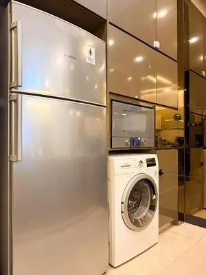 a refrigerator and a washing machine in a room at TRX Pavilion Top Floor Suite, Kid-Friendly Slide, Dorsett Bukit Bintang KL, Kuala Lumpur Malaysia in Kuala Lumpur