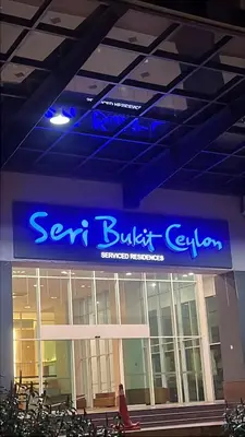 a sign for a building with a sign for a business at Seri Bukit Ceylon By Katy in Kuala Lumpur