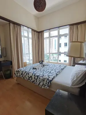 a bedroom with a bed with a blue and white blanket at Seri Bukit Ceylon By Katy in Kuala Lumpur