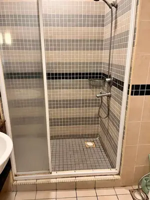 a shower with a glass door in a bathroom at Seri Bukit Ceylon By Katy in Kuala Lumpur