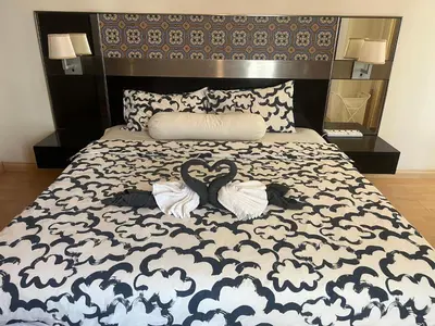 a bedroom with a bed with two swans on it at Seri Bukit Ceylon By Katy in Kuala Lumpur