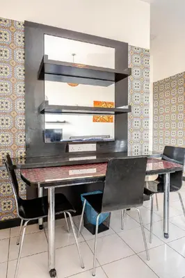a dining room with a table and chairs at Seri Bukit Ceylon By Katy in Kuala Lumpur