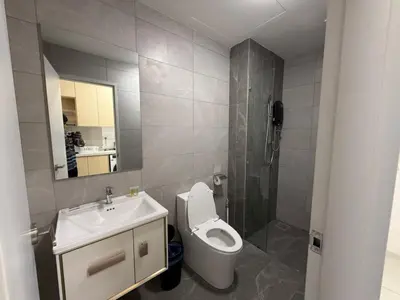 a bathroom with a toilet and a sink and a mirror at Majestic Residences KLCC By Cozy in Kuala Lumpur