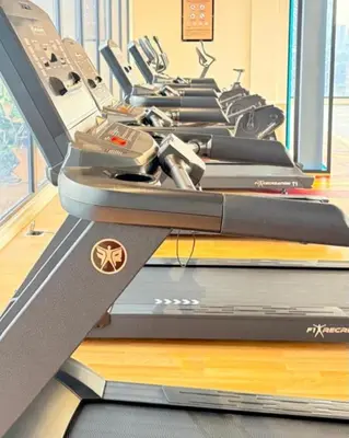 a row of treadmills in a gym at Majestic Residences KLCC By Cozy in Kuala Lumpur