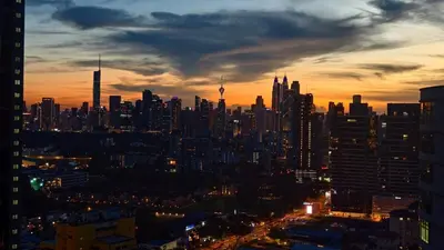 a view of a city skyline at sunset at The Elements Ampang A place of Tranquility Premium in Kuala Lumpur