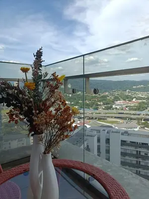 a vase filled with flowers sitting on top of a table at The Elements Ampang A place of Tranquility Premium in Kuala Lumpur