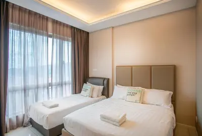 two beds in a hotel room with a window at Dorsett Residences Sri Hartamas Free Parking by COBNB Mont Kiara Kuala Lumpur in Kuala Lumpur
