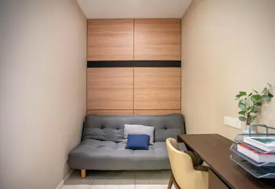 a couch in a room with a desk and a table at Dorsett Residences Sri Hartamas Free Parking by COBNB Mont Kiara Kuala Lumpur in Kuala Lumpur