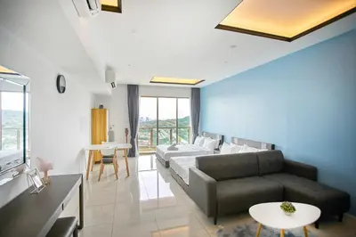 a living room with a couch and a table at Dorsett Residences Sri Hartamas Free Parking by COBNB Mont Kiara Kuala Lumpur in Kuala Lumpur