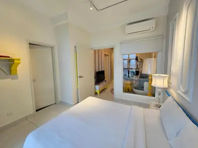 a white bedroom with a large bed and a window at RuangWaktu at Arte Mont Kiara in Kuala Lumpur