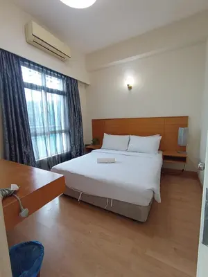 a bedroom with a large white bed and a window at Sky suite at Seri Bukit Ceylon in Kuala Lumpur