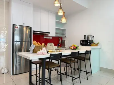 a kitchen with a counter with chairs and a refrigerator at Infinity Pool 7pax City Homestay KL Mrt Velo TRX in Kuala Lumpur