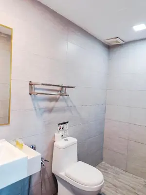 a bathroom with a white toilet and a sink at Arte Plus by Stay Relax in Kuala Lumpur