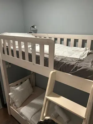 a wooden bunk bed with a ladder on it at V Residence Suites, Sunway Velocity by Rasbo Galaxy Suites in Kuala Lumpur