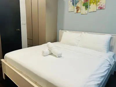 a white stuffed animal sitting on a bed at V Residence Suites, Sunway Velocity by Rasbo Galaxy Suites in Kuala Lumpur