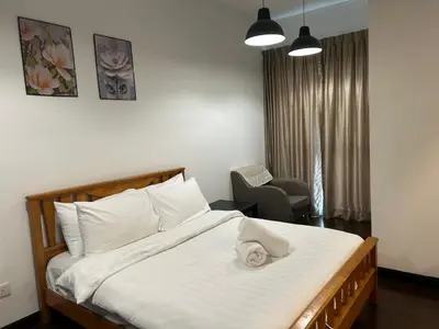a bedroom with a bed with a towel on it at V Residence Suites, Sunway Velocity by Rasbo Galaxy Suites in Kuala Lumpur