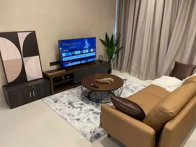 a living room with a couch and a tv at Novo Suites Kuala Lumpur by Nestaway Jalan Ampang in Kuala Lumpur