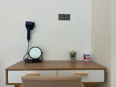 a desk with a mirror and a phone on a wall at Novo Suites Kuala Lumpur by Nestaway Jalan Ampang in Kuala Lumpur