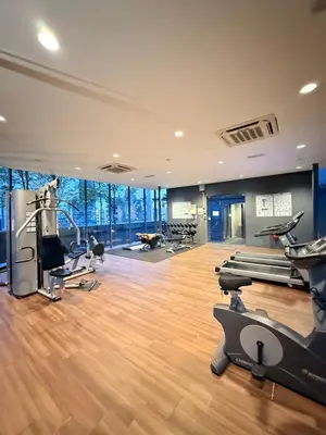a gym with treadmills and exercise equipment in a building at Dorsett Residence KL in Kuala Lumpur