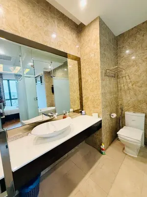 a bathroom with a sink and a toilet and a mirror at Dorsett Residence KL in Kuala Lumpur
