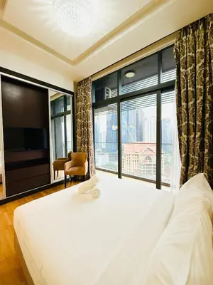 a bedroom with a large bed and a large window at Dorsett Residence KL in Kuala Lumpur