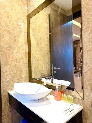 a bathroom with two sinks and a large mirror at Dorsett Residence KL in Kuala Lumpur