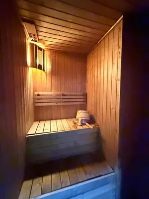 a sauna with a toilet in a wooden room at Dorsett Residence KL in Kuala Lumpur