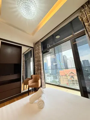 a bedroom with a bed and a large window at Dorsett Residence KL in Kuala Lumpur