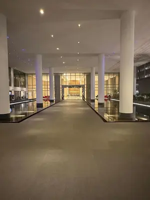 an empty hallway in a building with columns at KLCC Marc Residence by AZ Line in Kuala Lumpur