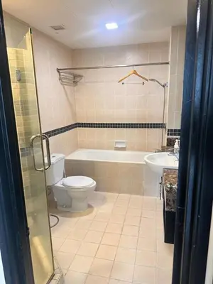 a bathroom with a toilet and a tub and a sink at AL Seri Bukit Ceylon in Kuala Lumpur