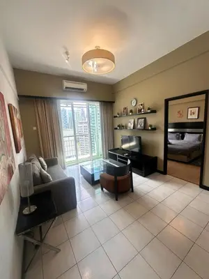 a living room with a couch and a mirror at AL Seri Bukit Ceylon in Kuala Lumpur