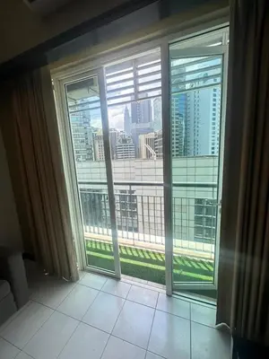 a room with a large window with a view of a city at AL Seri Bukit Ceylon in Kuala Lumpur