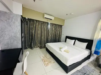 a bedroom with a large bed and a window at Studio Apartment KLCC Area in Kuala Lumpur