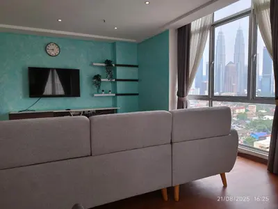 a living room with a couch and a large window at Arina Uniti Kampung Baru HKL - Idealhub in Kuala Lumpur