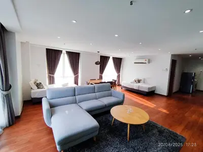 a living room with a blue couch and a bed at Arina Uniti Kampung Baru HKL - Idealhub in Kuala Lumpur