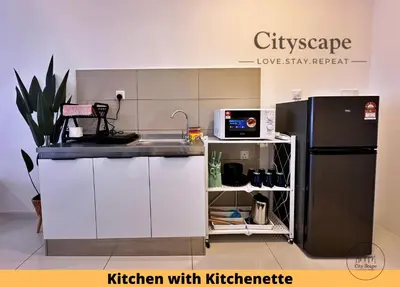 a kitchen with a sink and a refrigerator at Majestic Residence Kuala Lumpur by Cityscape in Kuala Lumpur