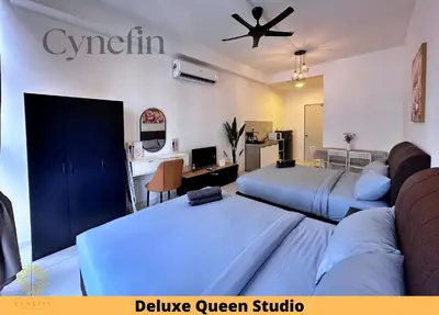 a hotel room with two beds and a desk at Majestic Residence Kuala Lumpur near Bukit Bintang & Chow Kit in Kuala Lumpur