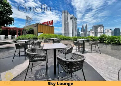 a patio with tables and chairs with a city skyline at Majestic Residence Kuala Lumpur near Bukit Bintang & Chow Kit in Kuala Lumpur