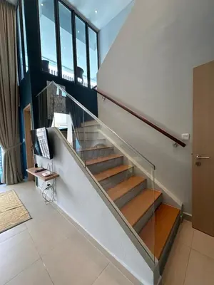 a staircase with glass railing in a house at The Colony By Infinitum With Rooftop Pool in Kuala Lumpur