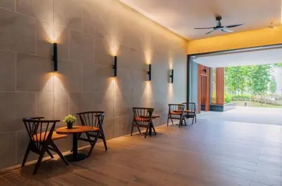 a dining room with chairs and tables and a ceiling fan at TRX Agile Bukit Bintang Cozy 2 Bedroom and 1 Living Room Suites in Kuala Lumpur