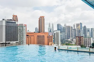 a pool on the roof of a building with a city at D'Majestic by Aspire Suites in Kuala Lumpur