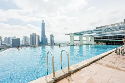 a swimming pool with a city skyline in the background at D'Majestic by Aspire Suites in Kuala Lumpur