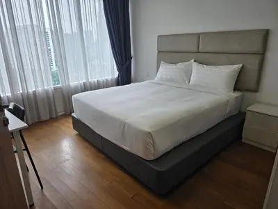 a bedroom with a large bed with white sheets at Vortex suites klcc by KAZI in Kuala Lumpur