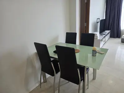 a dining room table with four chairs around it at Vortex suites klcc by KAZI in Kuala Lumpur