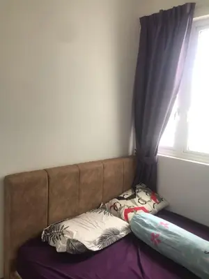 a bed with two pillows sitting next to a window at Sentul Kuala Lumpur Private Medium Room Home Stay Shared Common Area With Host in Kuala Lumpur