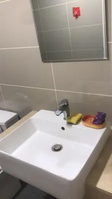 a white bathroom sink with a faucet on it at Sentul Kuala Lumpur Private Medium Room Home Stay Shared Common Area With Host in Kuala Lumpur