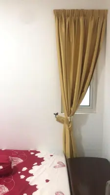 a bedroom with a bed and a window with a curtain at Sentul Kuala Lumpur Private Medium Room Home Stay Shared Common Area With Host in Kuala Lumpur